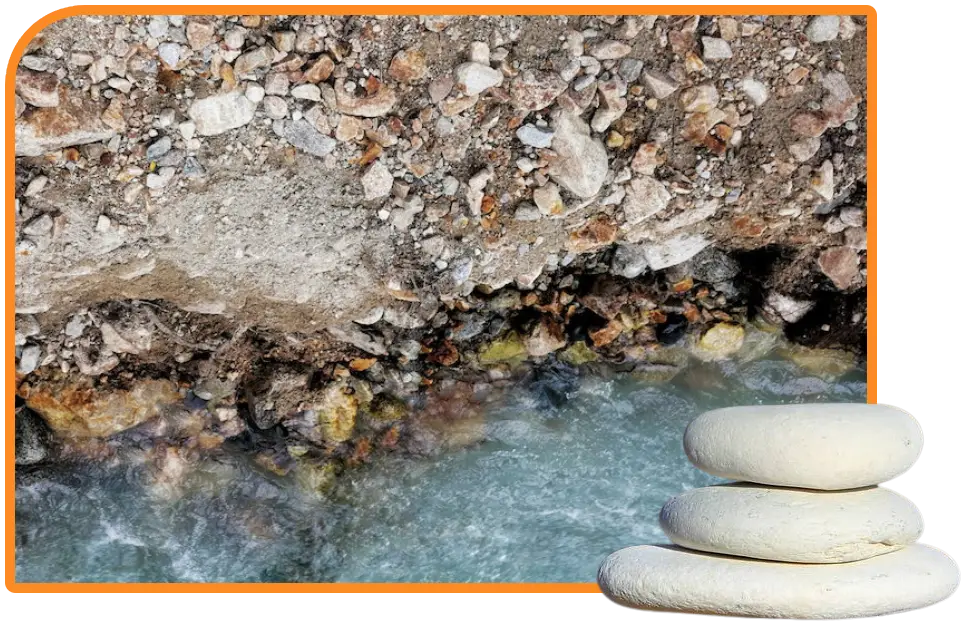 a stack of white rocks next to a river